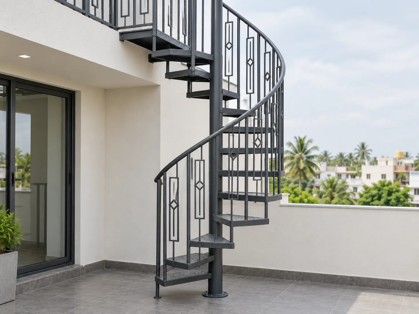 Spiral staircase with a central column, chequer-plate treads and a curved handrail on a terrace